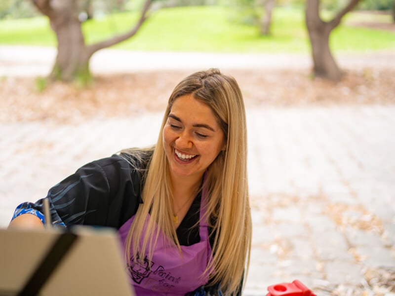 woman smiling at paint and sip class